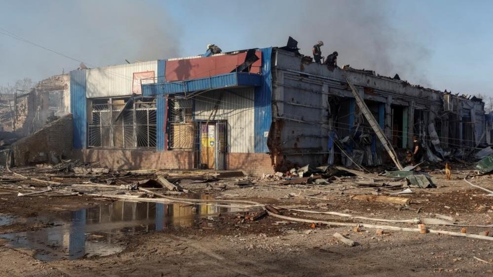 Rescuers work at the site of Russian air strikes, amid Russia's attack on Ukraine, in the village of Lyptsi, Kharkiv region, 10 April 2024.