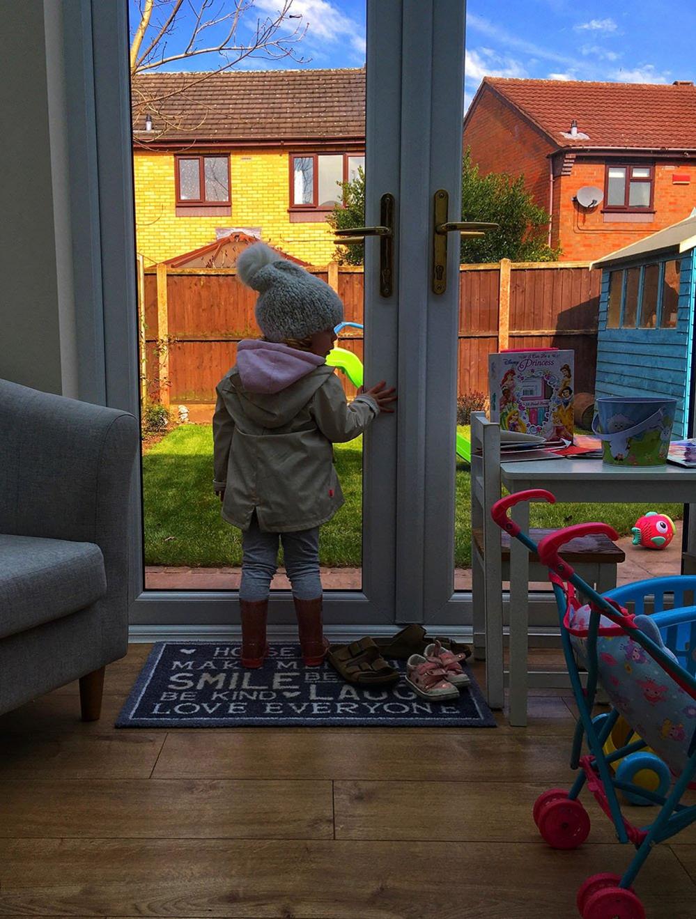 Child at a glass door