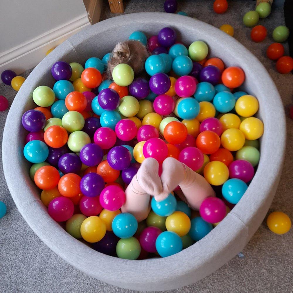 Girl's feet in a pool of balls