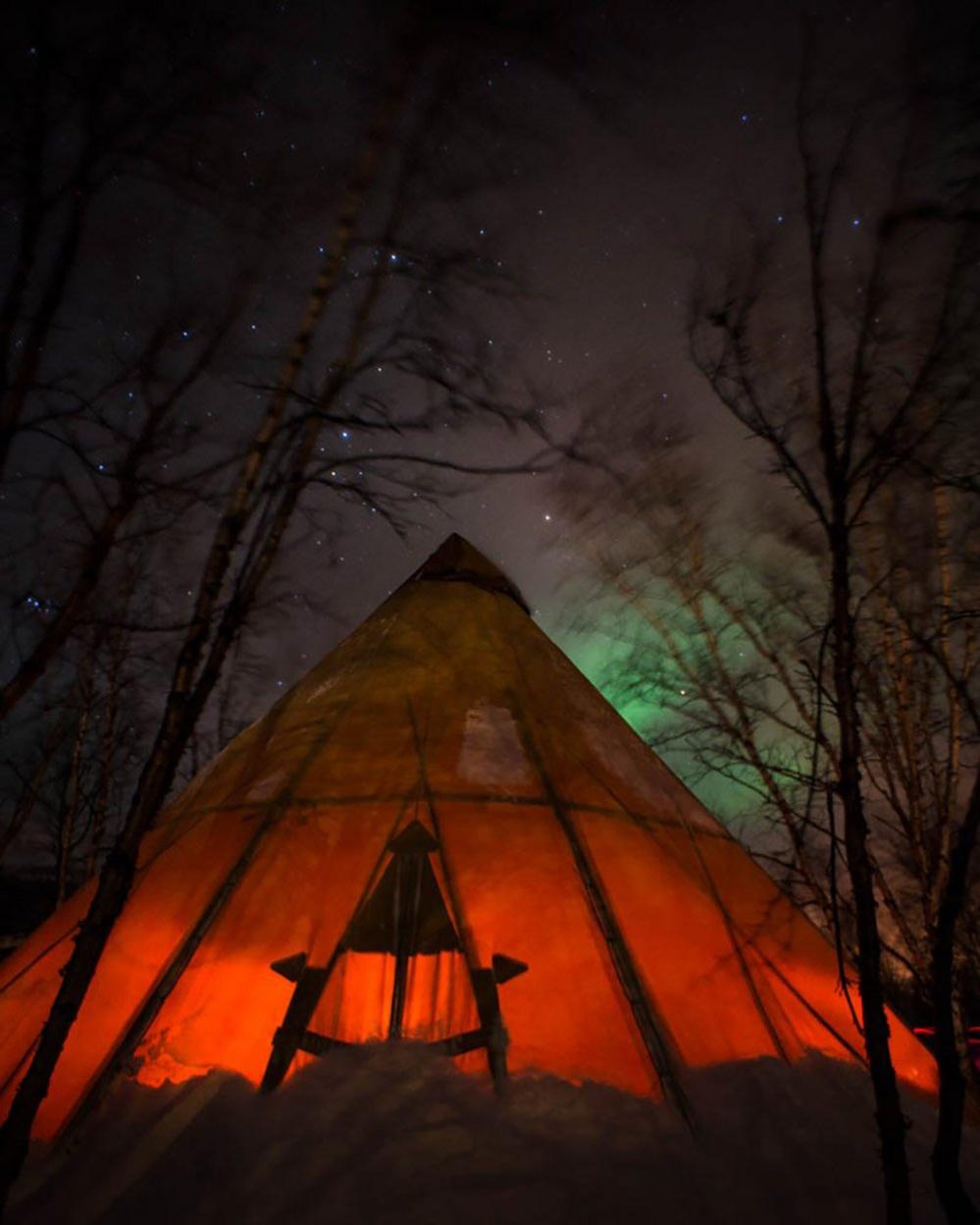 Tepee in a forest at night