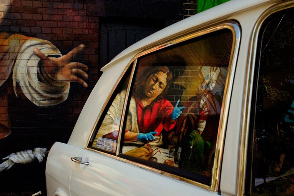 Mural reflected in a car window