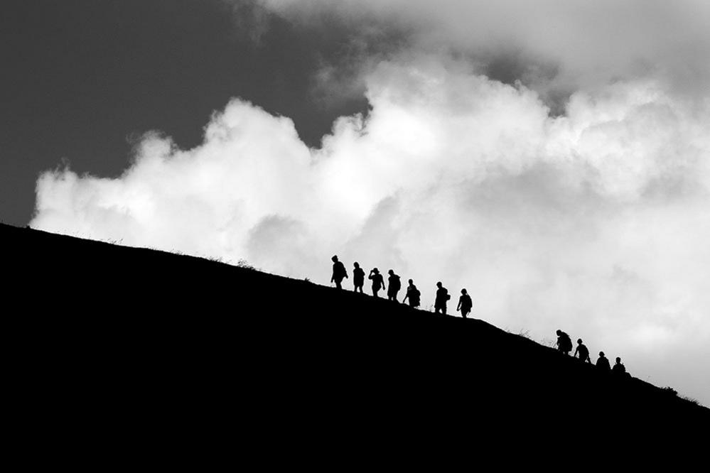 People on the brow of a hill