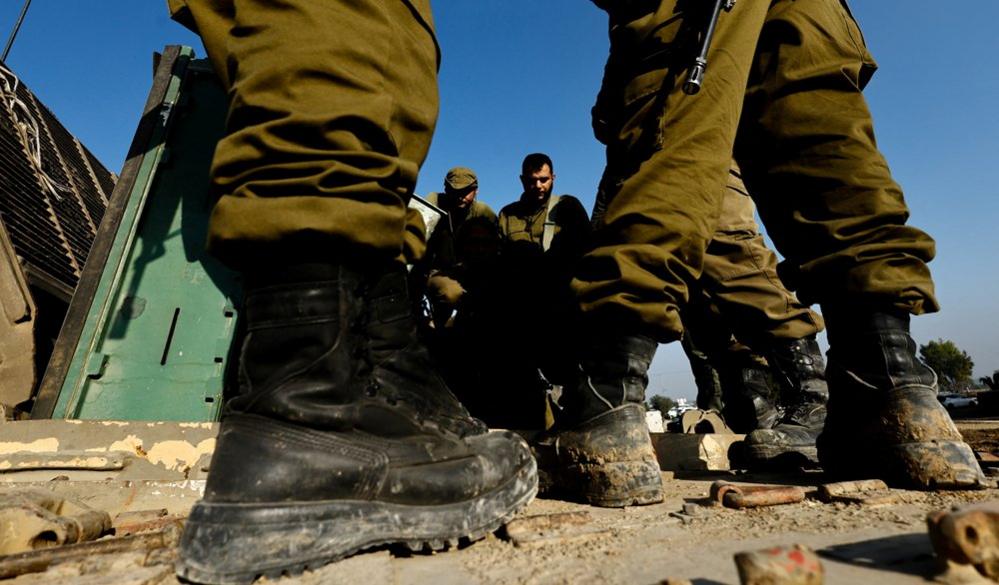 Israeli soldiers standing, Israel: Israeli soldiers prepare on the Israeli side of the border with Gaza in southern Israel, December 18, 2023