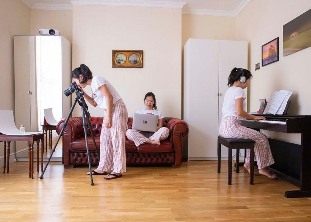 Multiple exposure of a photographer at home