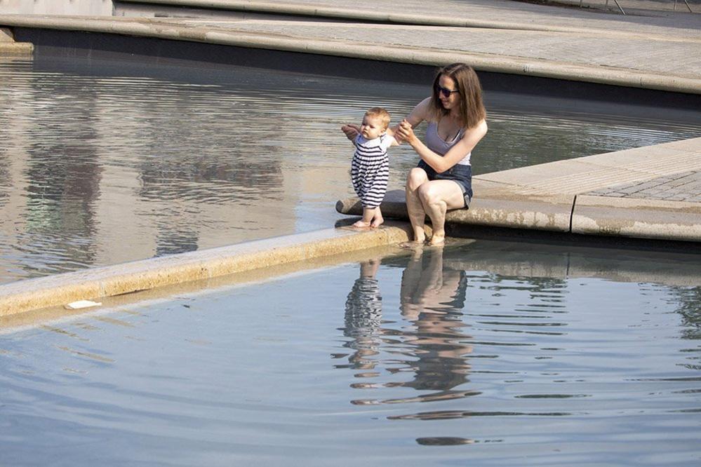 Mother and daughter beside a pond