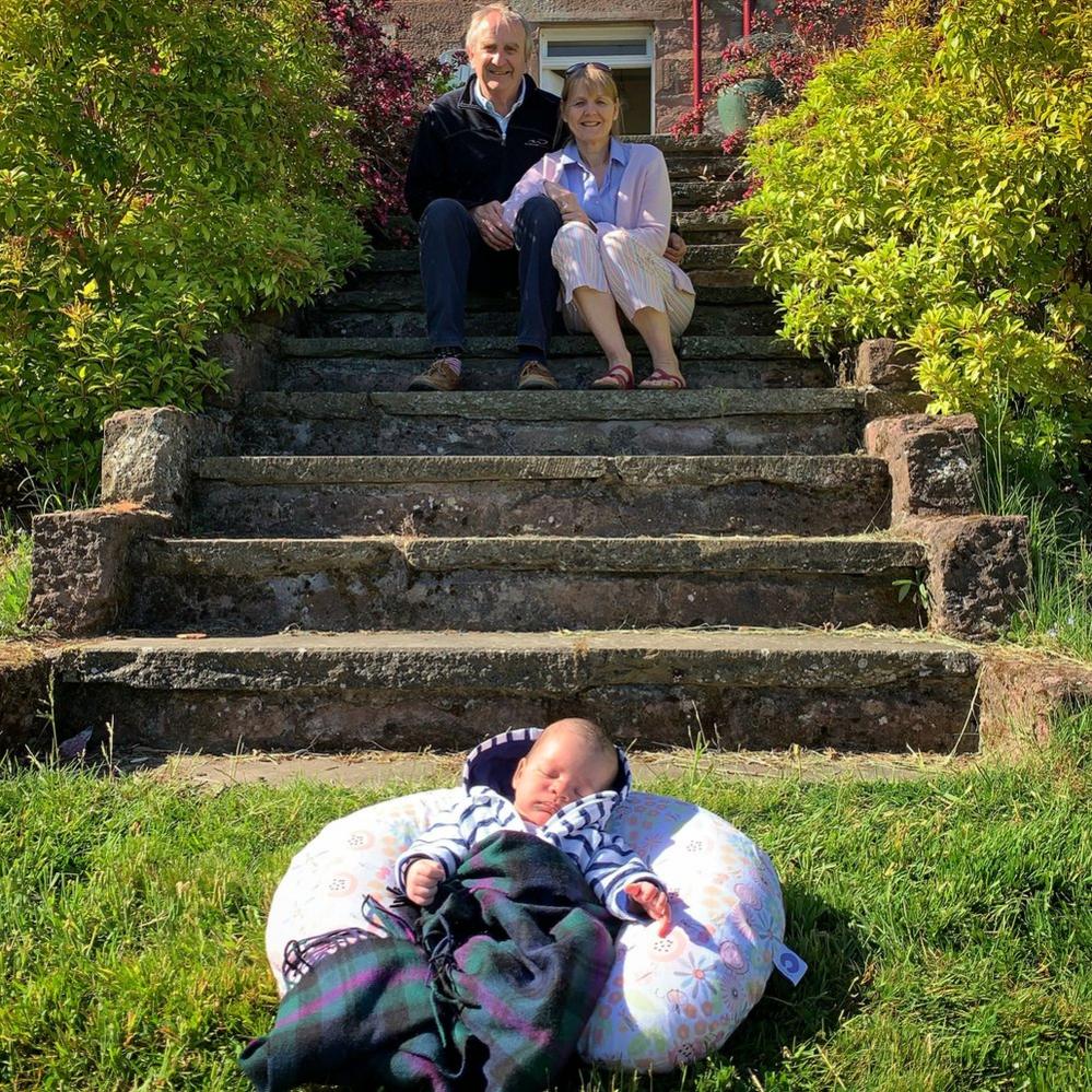 Grandparents meet their new grandchild