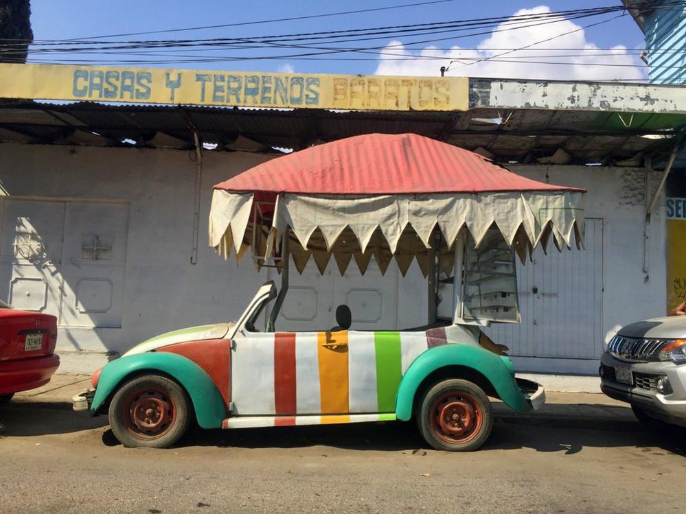 Stripey Volkswagen Beetle underneath a canopy shade