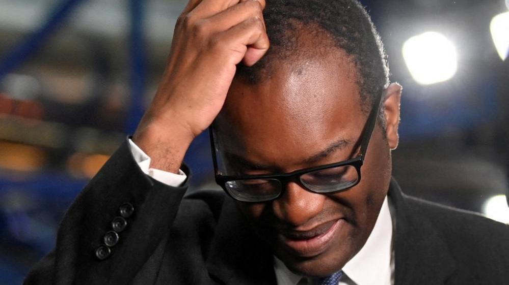 Kwasi Kwarteng scratches his head