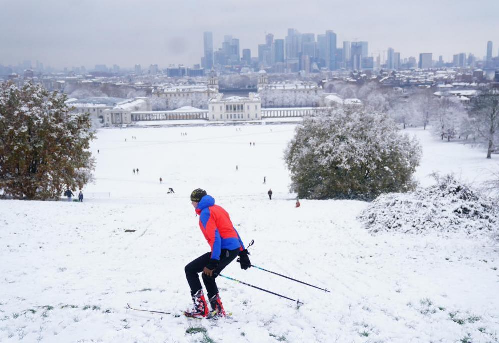 A person skis in the snow at Greenwich Park, London