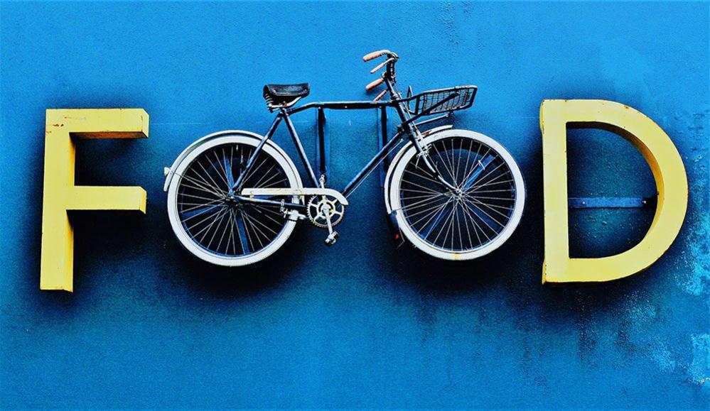 Food sign with a bicycle forming the letter O