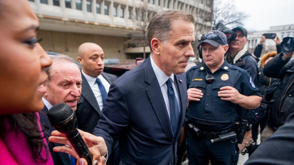 Hunter Biden flanked by reporters as he arrives for a closed-door committee hearing