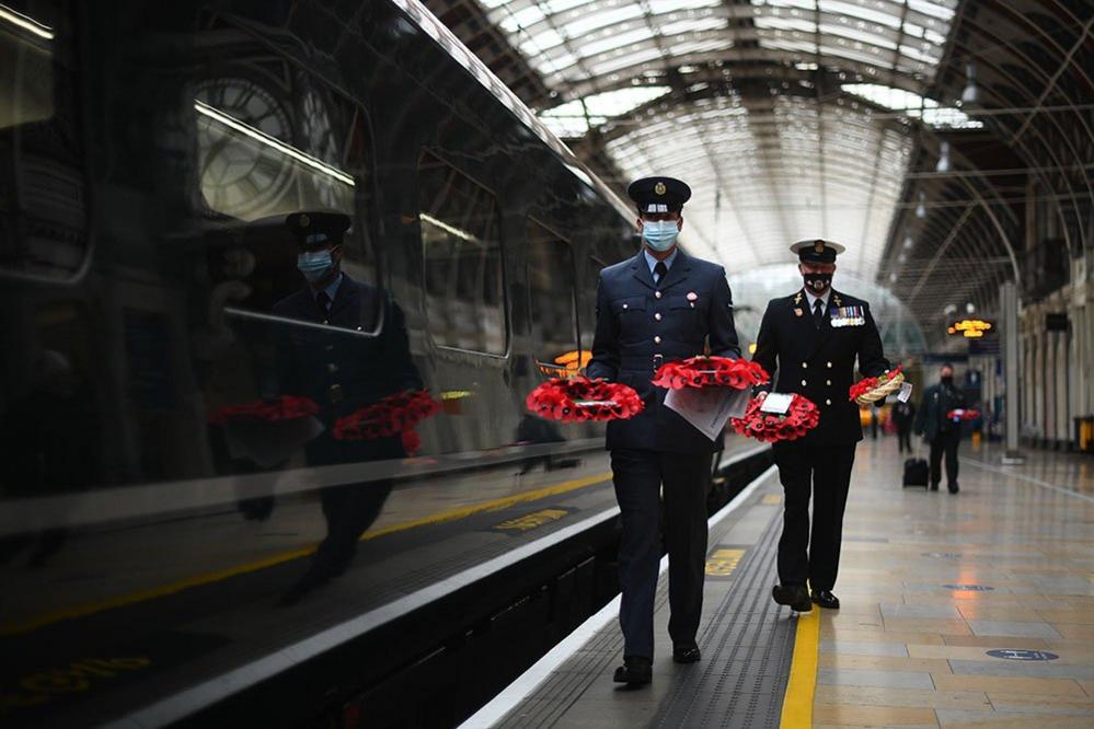 Military personnel carry poppy wreaths at Paddington Station in London, for 'Poppies to Paddington'.