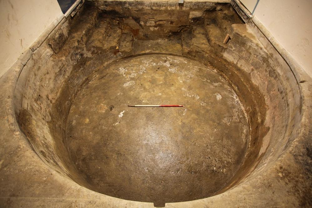 The cold bath from overhead showing the steps with a measuring stick in the middle