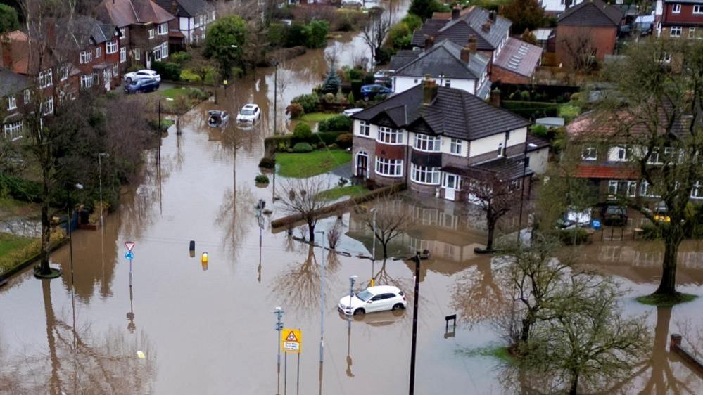 Aerial shot showing flooded suburban street in Manchester