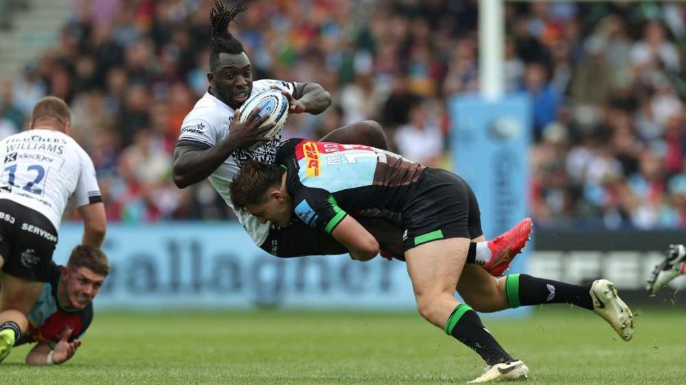 Oscar Beard of Harlequins dump tackles Bristol's Gabriel Ibitoye