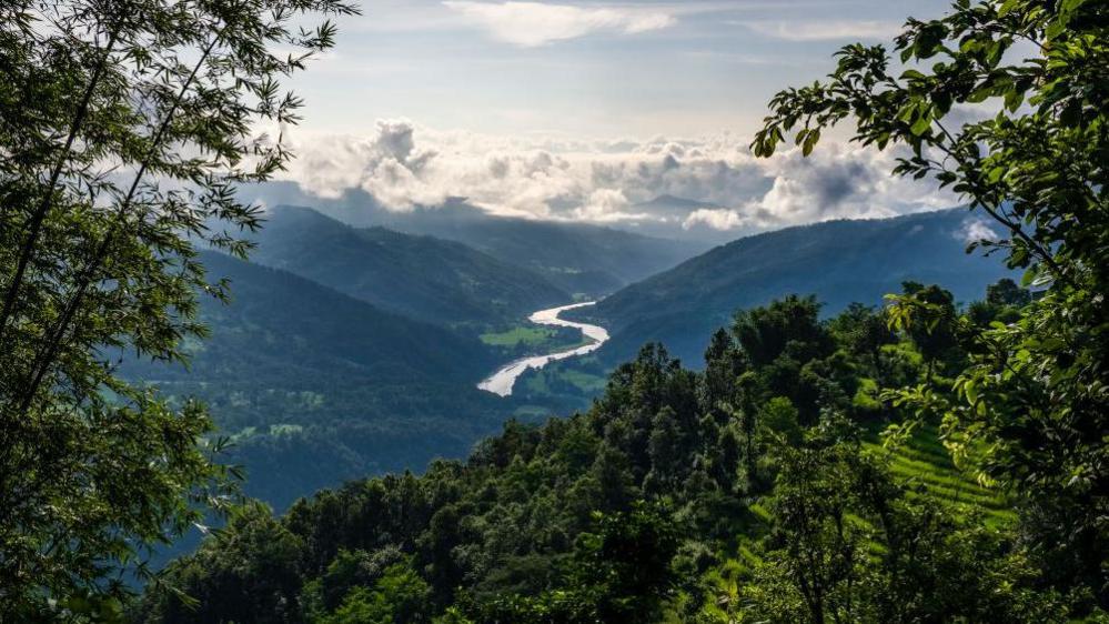 Aerial view of the Arun valley toward south, monsoon clouds covering the plains. 