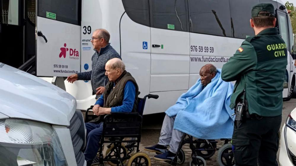 Elderly people are moved from their care home after a fire at Jardines De Villafranca