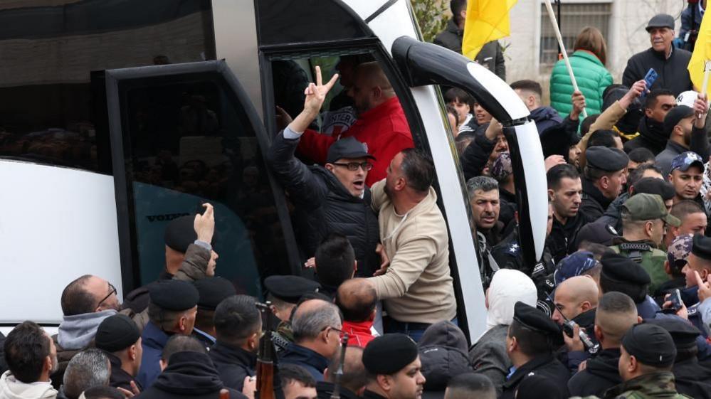 A released Palestinian prisoner shows a victory sign after arriving in the West Bank city of Ramallah. Photo: 8 February 2025