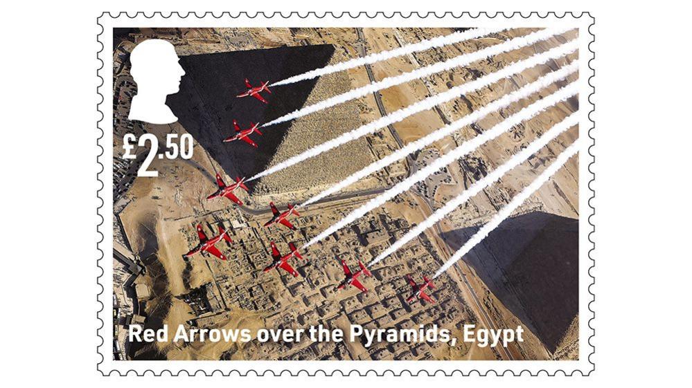 stamp outline, showing red arrows flying over pyramids in egypt