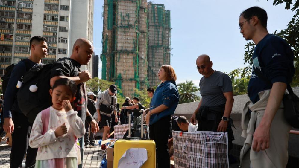 Volunteers distribute supplies at the scene of the Tai Po apartment fire in Hong Kong, China, 28 November 202