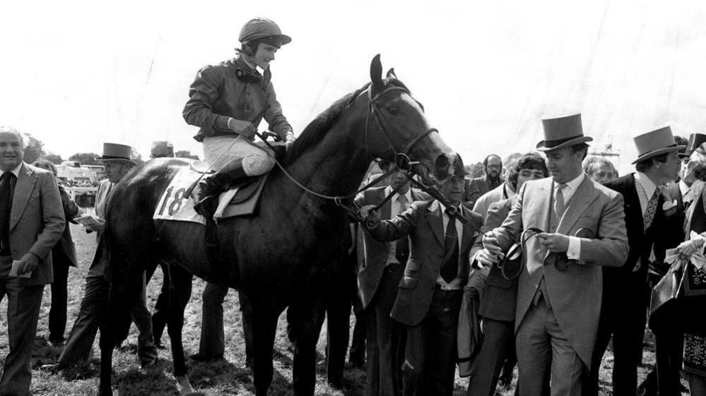 File photo dated 03/06/81 of Shergar during the lead in by owner Aga Khan (top hat) with jockey Walter Swinburn after winning the Derby Stakes Classic at Epsom. 