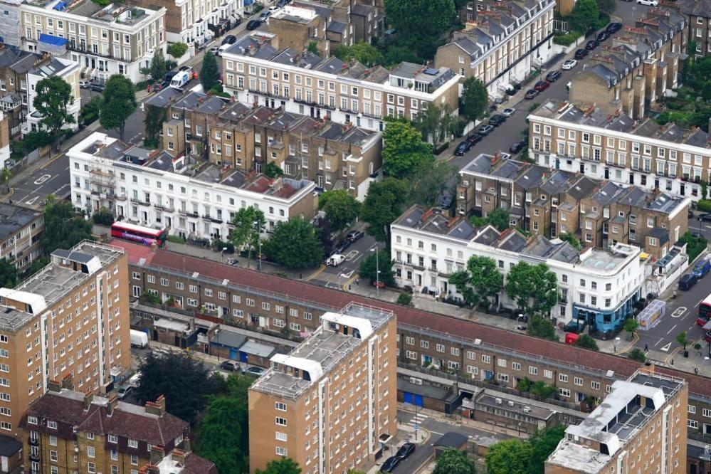 An aerial view of terraced housing and a block of flats in west London.