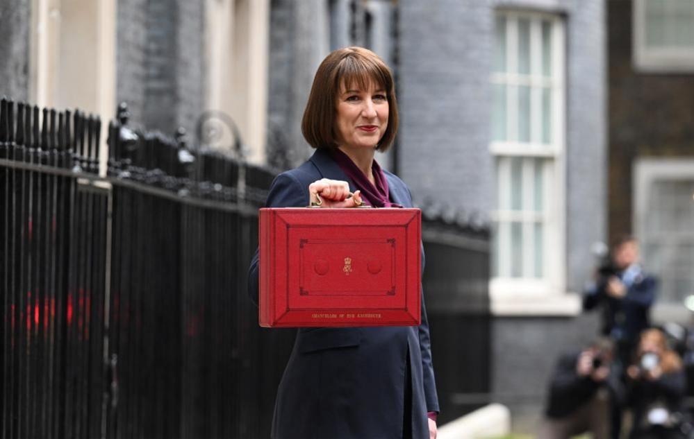 Chancellor Rachel Reeves seen standing outside 11 Downing Street holding the chancellor's red red box.