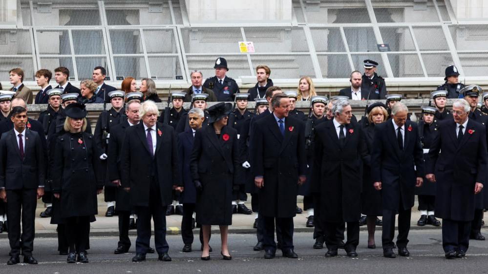 Rishi Sunak, Liz Truss, Boris Johnson, Theresa May, David Cameron, Gordon Brown, Tony Blair and John Major stand next to one aother