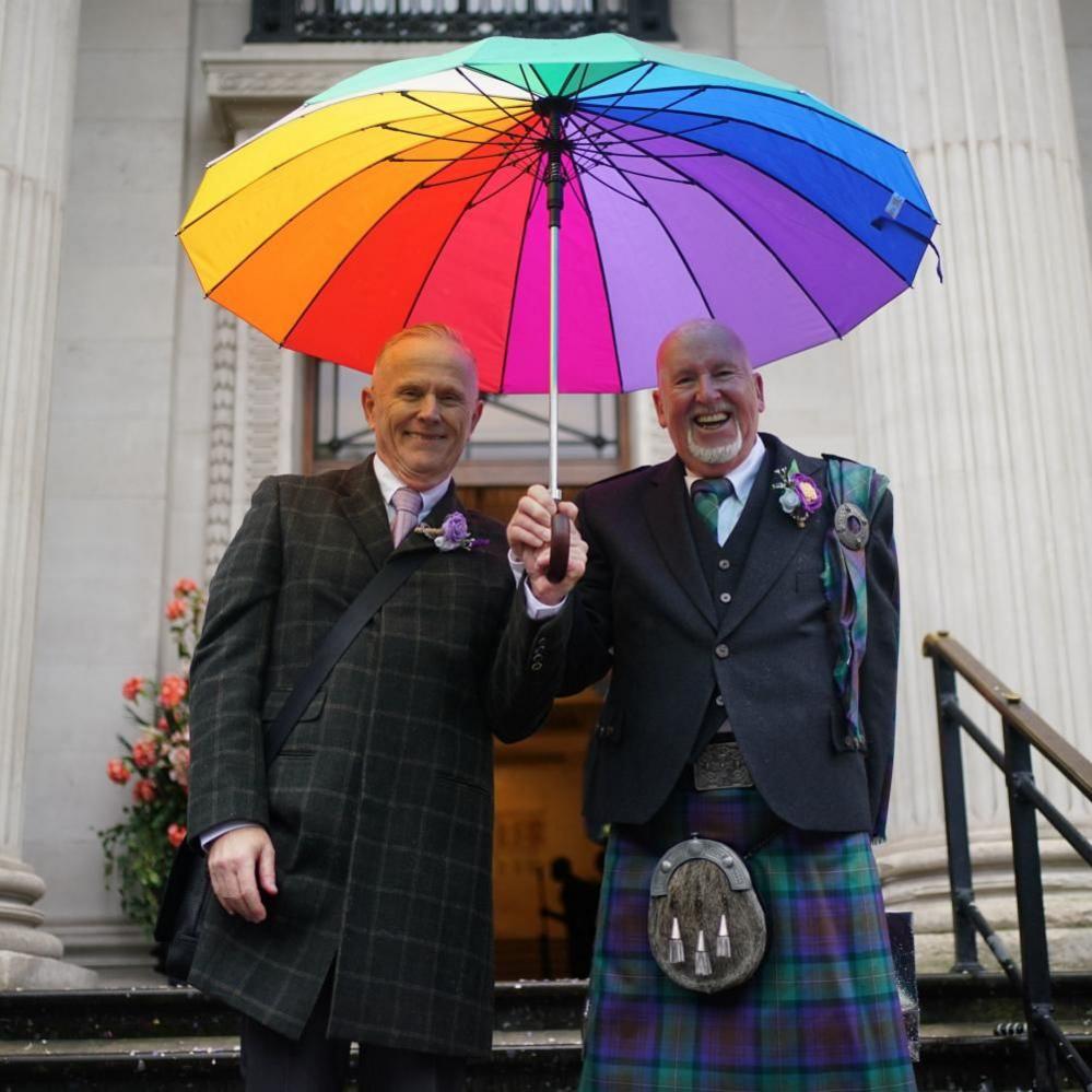 Andy Lambert, 68, (left) and Mel Fawcus, 73, from Shepherd's Bush, London, on the steps at Old Marylebone Town Hall 