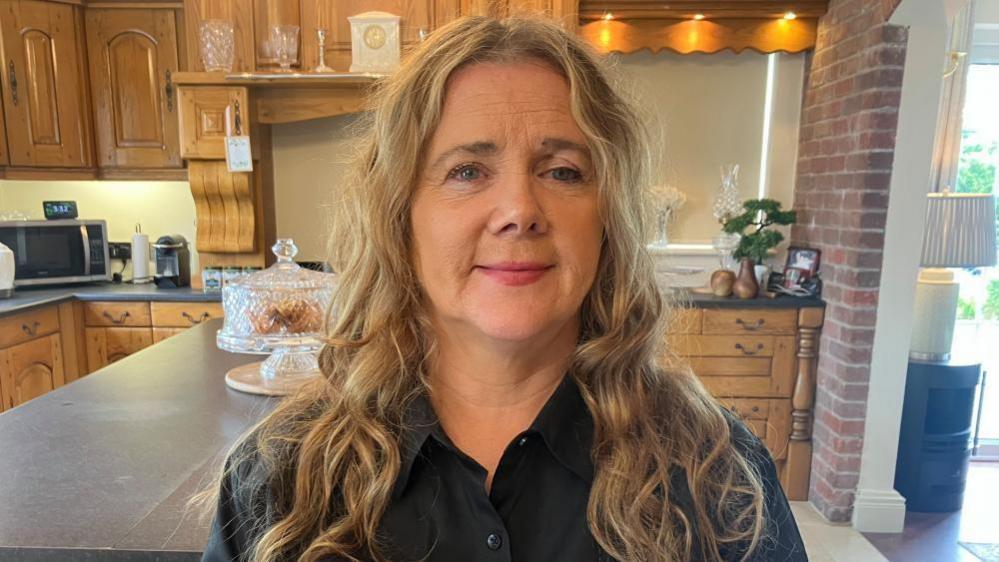 Blonde woman in a kitchen 