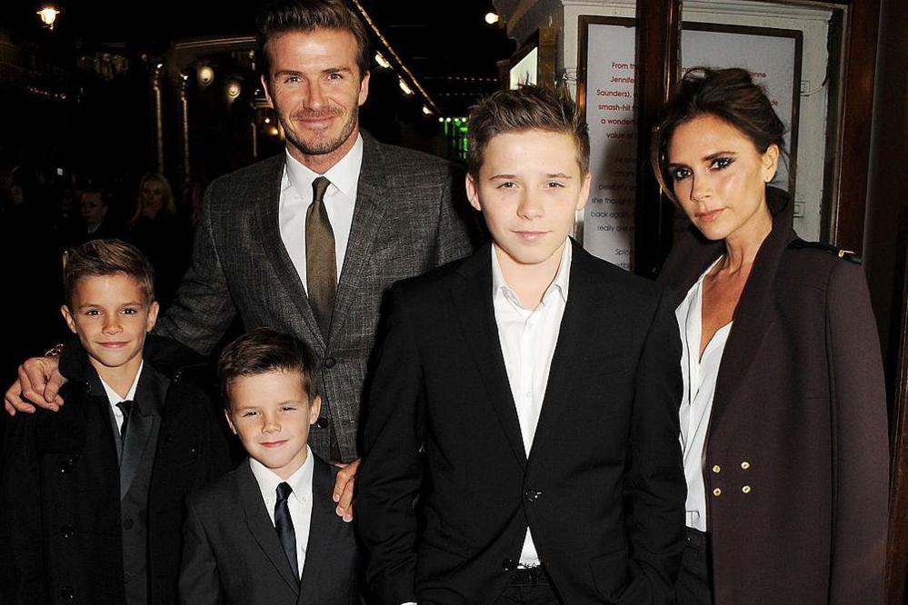 Brooklyn (front centre) dressed in a blazer as a young teen, posing with his family at a gala performance of Spice Girls musical Viva Forever