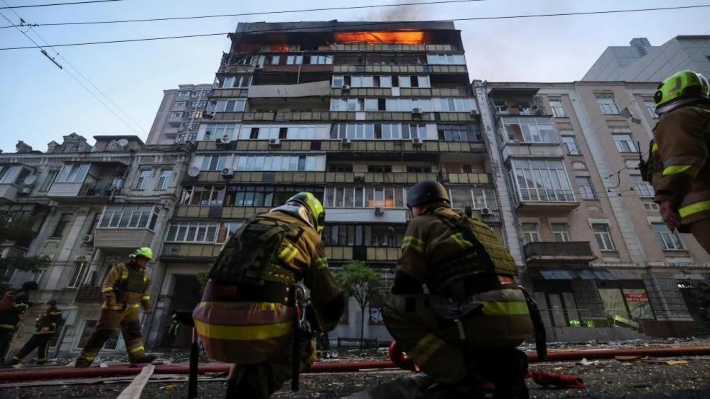 firefighters at scene of drone strike in Kyiv, 10 July