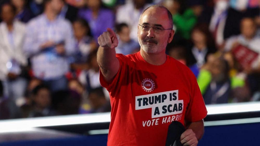 Shawn Fain wearing a "Trump is a Scab" shirt