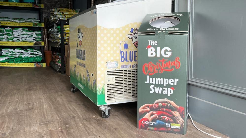 A Big Christmas Jumper Swap donation box inside Woodthorpe Plant Shop.