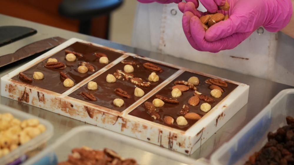 Nuts being added to chocolate bars