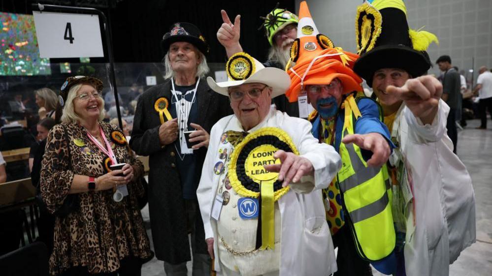 Monster Raving Loony Party candidate Howling Laud Hope with supporters at the Makerfield by-election on Thursday