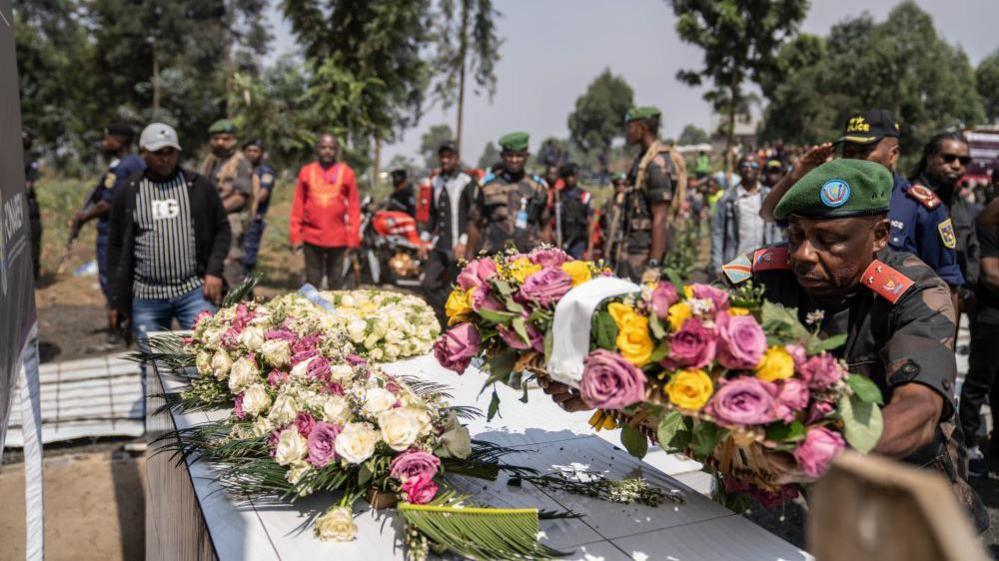 A government official lays down wreaths for the seven victims of the Bweremana bombing in Democratic Republic of Congo on 2 August 2024.  