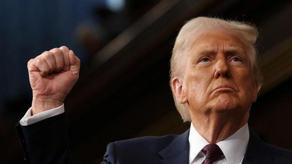 Trump raises a clenched fist during his address to Congress