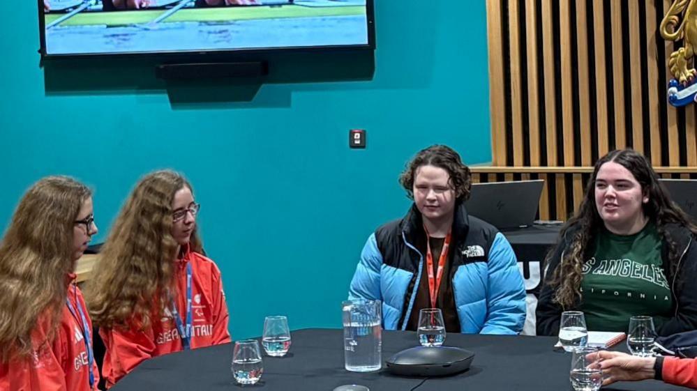 Anna Fogden (right) and fellow student Tilly Gerra (centre) interviewing Scarlett and Eliza Humphrey (left) in a conference room in the Senate building.