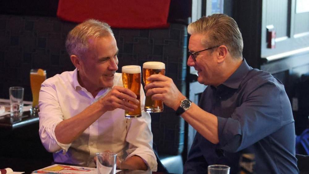Canada's Prime Minister Mark Carney and Britain's Prime Minister Kier Starmer watch a Florida Panthers vs. Edmonton Oilers Stanley Cup final NHL hockey playoff game at a pub in Ottawa, Canada, June 14, 2025.