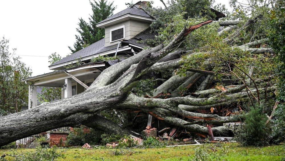 A large oak lies on a home in Anderson, South Carolina 