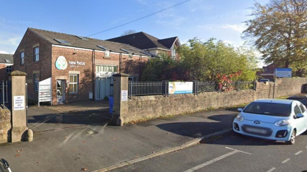 A Google street view of the brick office building in Cottam 