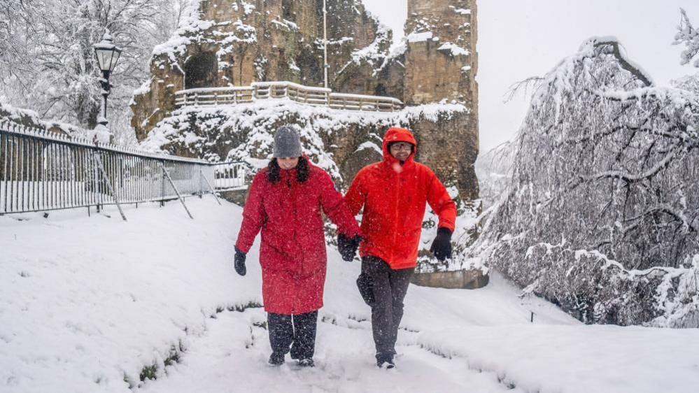 People walking in snowy conditions at Knaresborough Castle in Knaresborough, Yorkshire