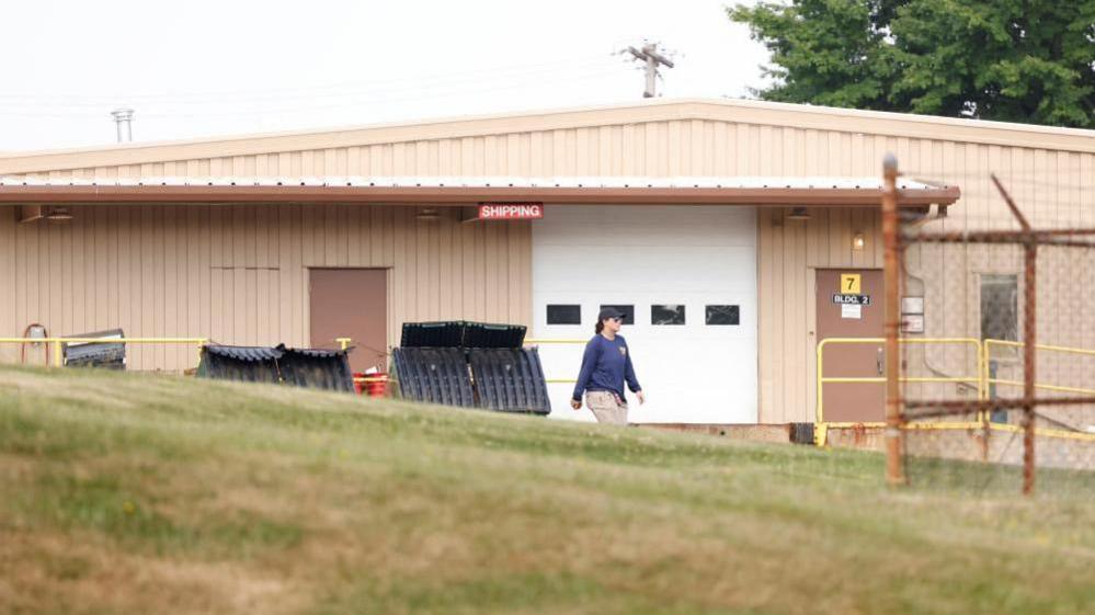 A member of the FBI Evidence Response Team, works near the building where a gunman was shot dead by law enforcement, near the stage where Republican presidential candidate and former U.S. President Donald Trump survived an assassination attempt during a rally the day before, in Butler, Pennsylvania, U.S. July 15, 2024.