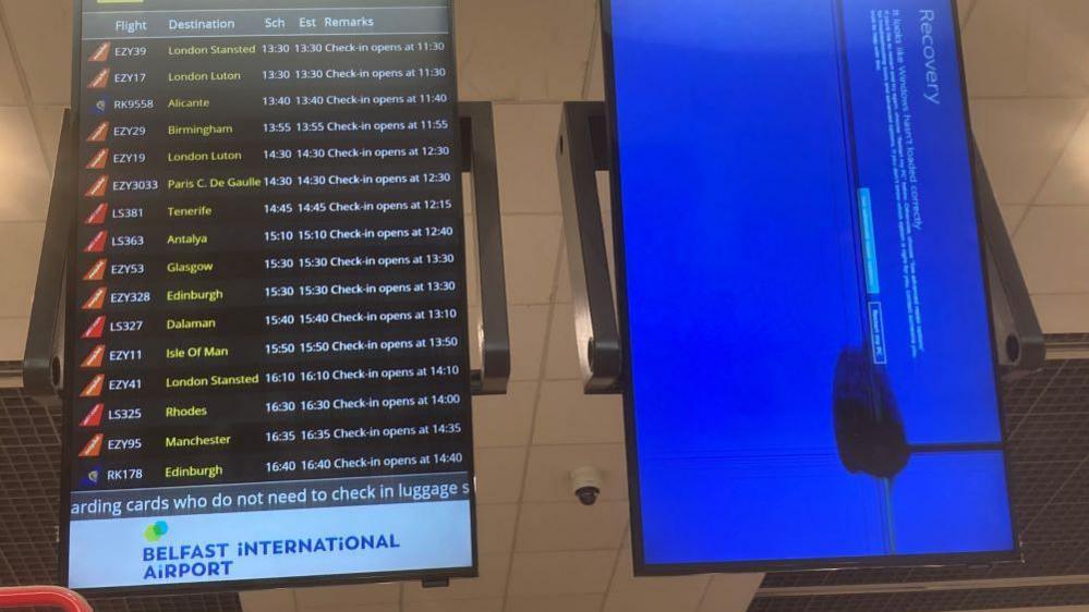 Two airport signs at Belfast International Airportt, one working and the other not