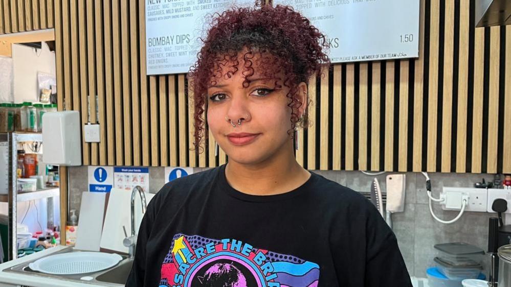 Aleisha Hartsilver, an employee of Mac Lovin in St Martin's Square, stood behind the shop counter.