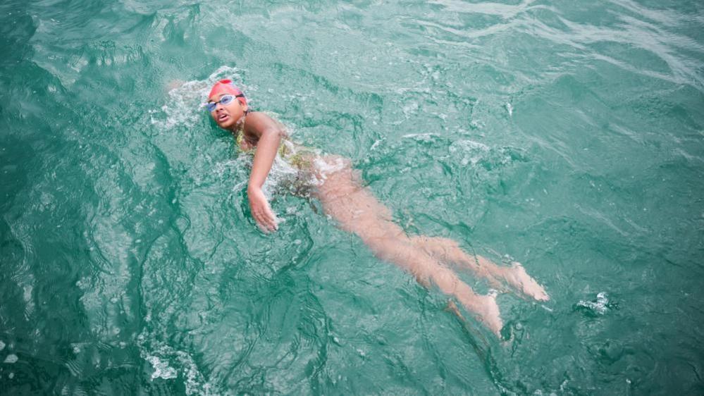 Prisha Tapre in a swimming costume and crossing the English Channel