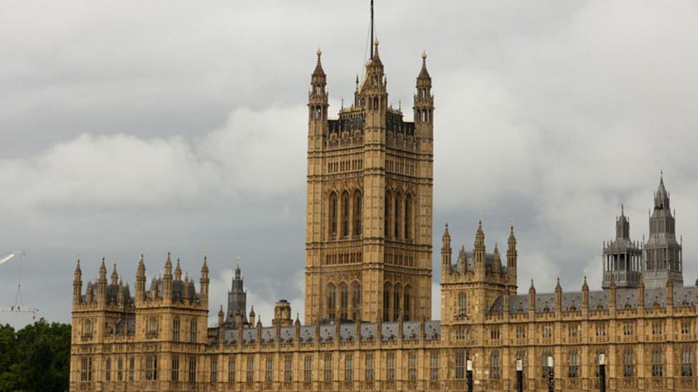The Houses of Parliament on a grey day in London.