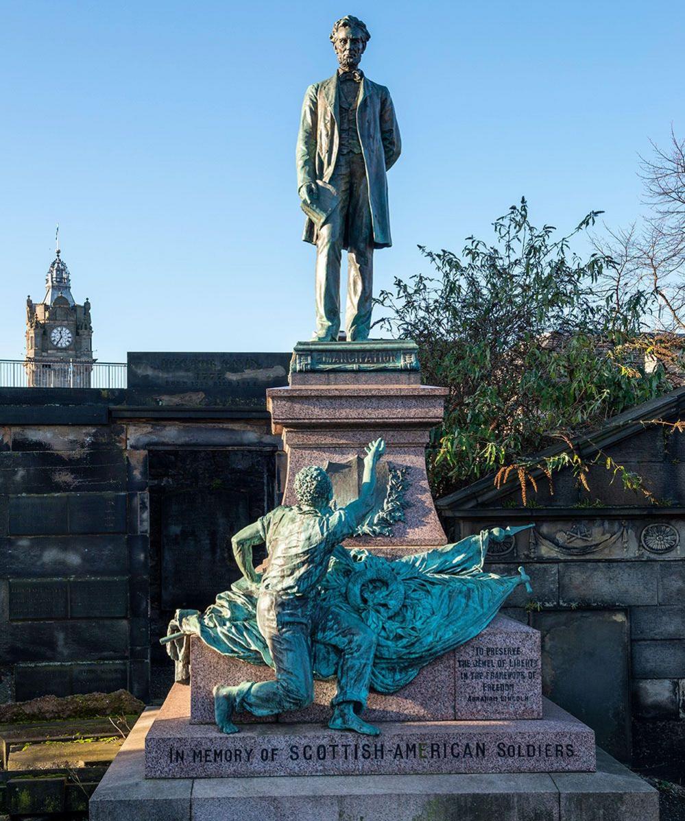 The Civil War memorial in Old Calton Burial Ground, depicting Abraham Lincoln. The Balmoral clock tower is in the background.