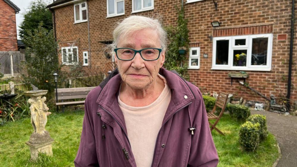 Glenis Downs, a resident of Burton Joyce, stood in her front garden which tends to flood frequently.